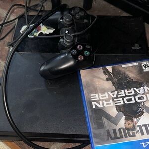 Sony PlayStation Console with Black Controller and Game